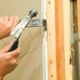 Using a pry bar and hammer to remove sheetrock