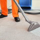 person steam cleaning carpet