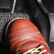 foot in shoe pressing brake pedal
