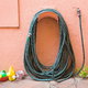 A garden hose on the side of a house.