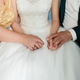 people holding hands with person in a wedding dress