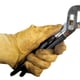 A hand in work gloves holding black-handled pliers.