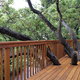 deck with railing surrounded by trees