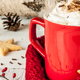 Christmas coffee setup with star cookies, mug, and whipped cream