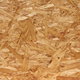 A close-up image of oriented strand board.