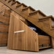 set of drawers and cabinets under wooden stairway
