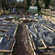 Raised garden beds covered in plastic for the winter.