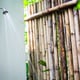 An outdoor shower with bamboo wall