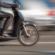 blurring image of rider on a scooter