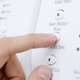 hand pushing buttons on an energy efficient clothes drier