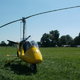 yellow gyrocopter on the grass