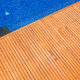 A pool deck made from teak wood.