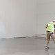 a person cleaning concrete floors
