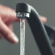 hand turning sink faucet off