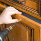 cabinet being repaired with a drill