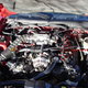 The engine under the hood of a red car.