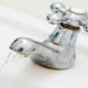 A faucet suffering from low water pressure due to limescale buildup.