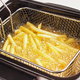 French fries in an electric deep fryer basket.