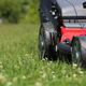 A close-up of a lawnmower on grass.