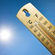 thermometer with sun in the background