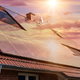 solar panels on roof in sunset