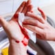 bleeding hand with bandage in kitchen