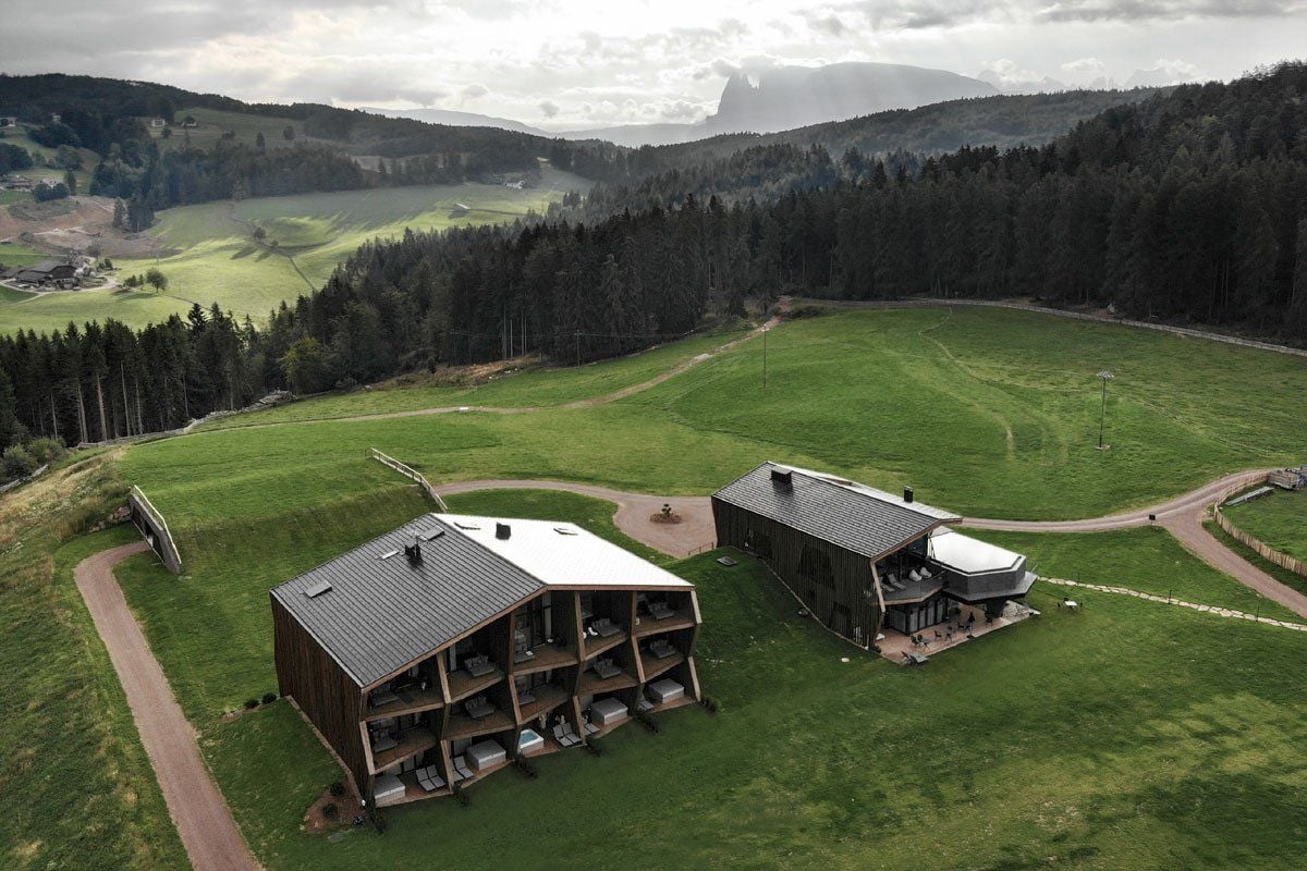 Aerial view of the two barn-like buildings that make up noa's new AEON Hotel in northern Italy.