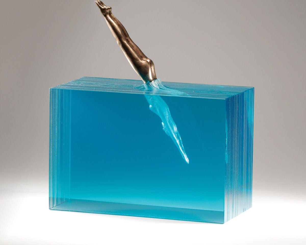 A breathtaking glass sculpture by Australian artist Ben Young, depicting a diver plunging into a block of water.