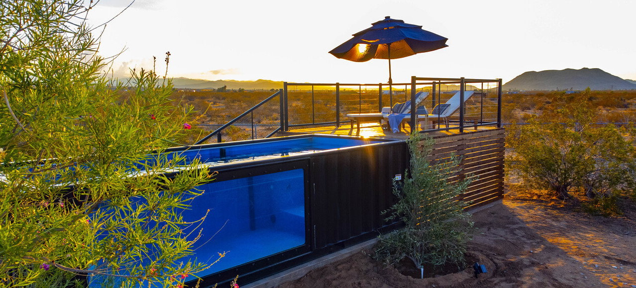 Luxurious ModPools shipping container pool outside the renovated home at 636 Valencia Drive in Landers, California.