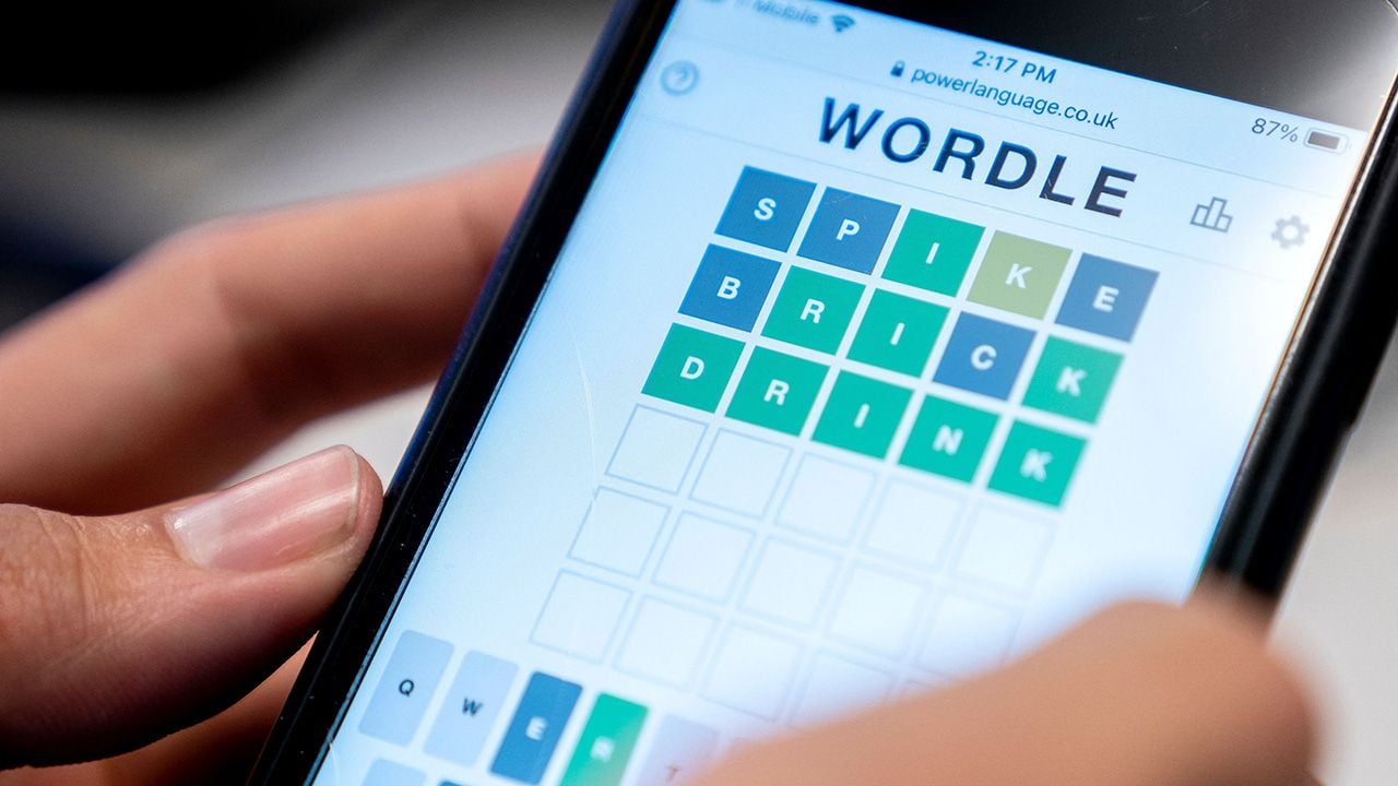 Smartphone user playing Wordle.