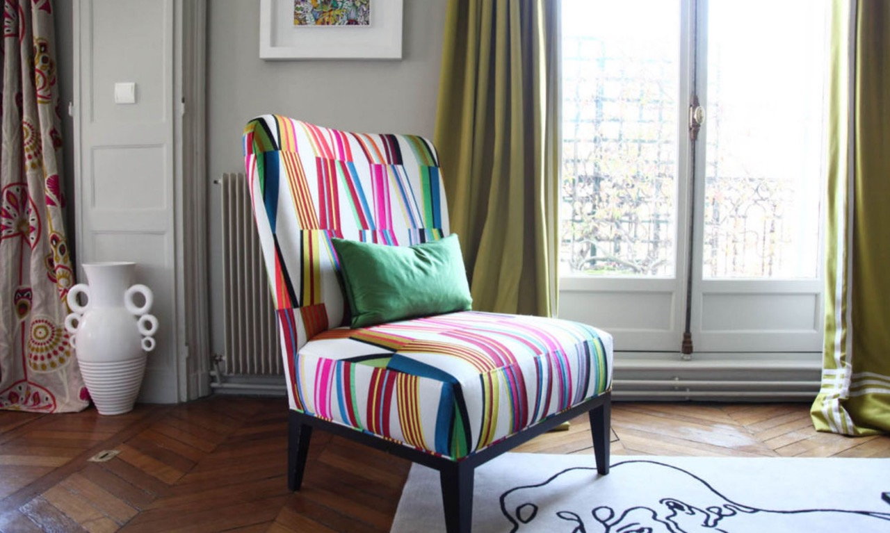 Colorful upholstered chair in the Pierre Frey owners' modern Paris apartment. 
