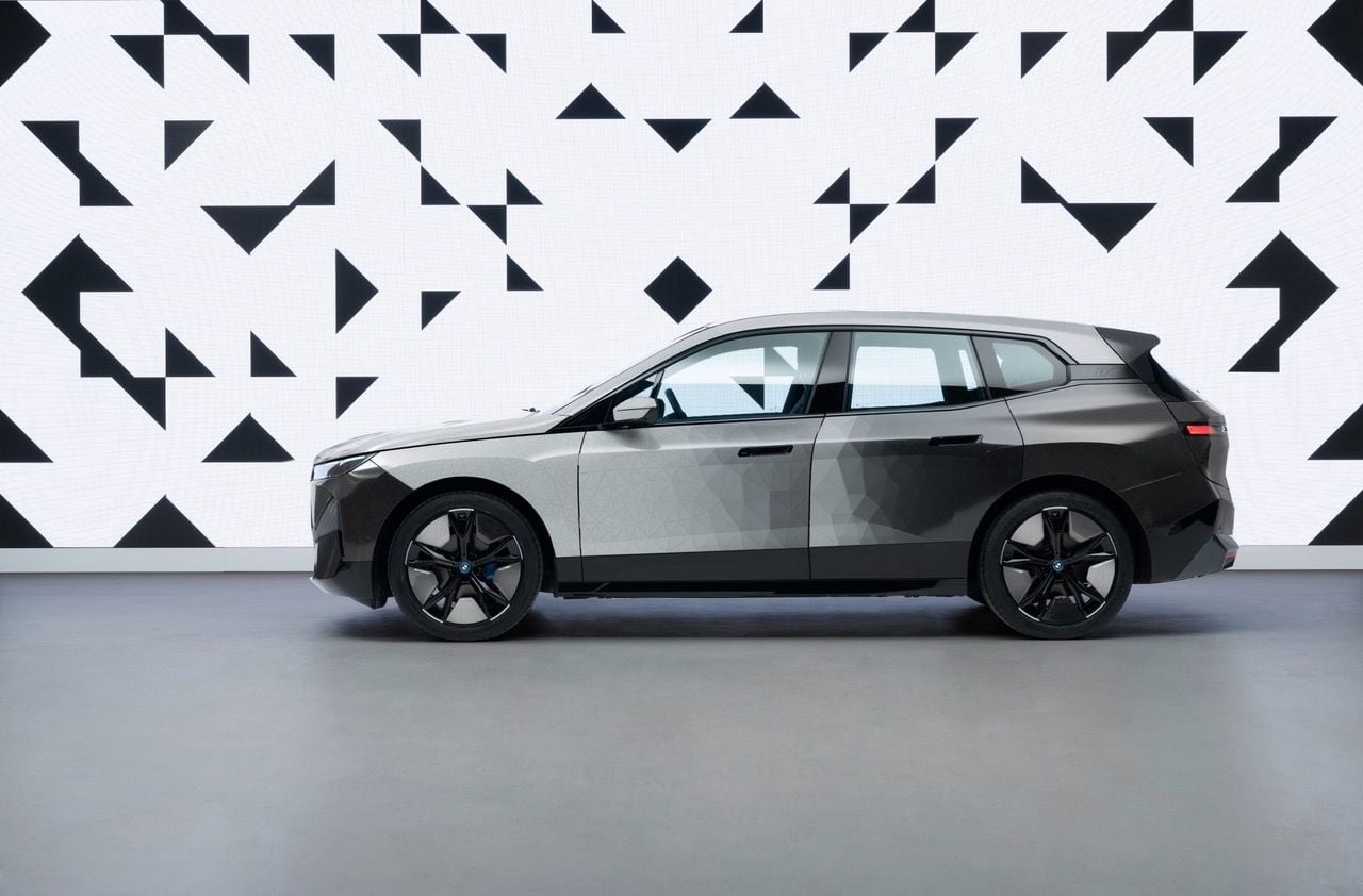 Side view of BMW's color-changing iX electric SUV as it transitions from white to black. 
