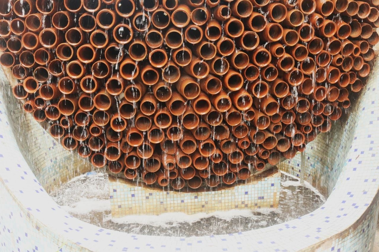 Water drips down from the clay pipes of Ant Studio's evaporative cooling structure, the Beehive.