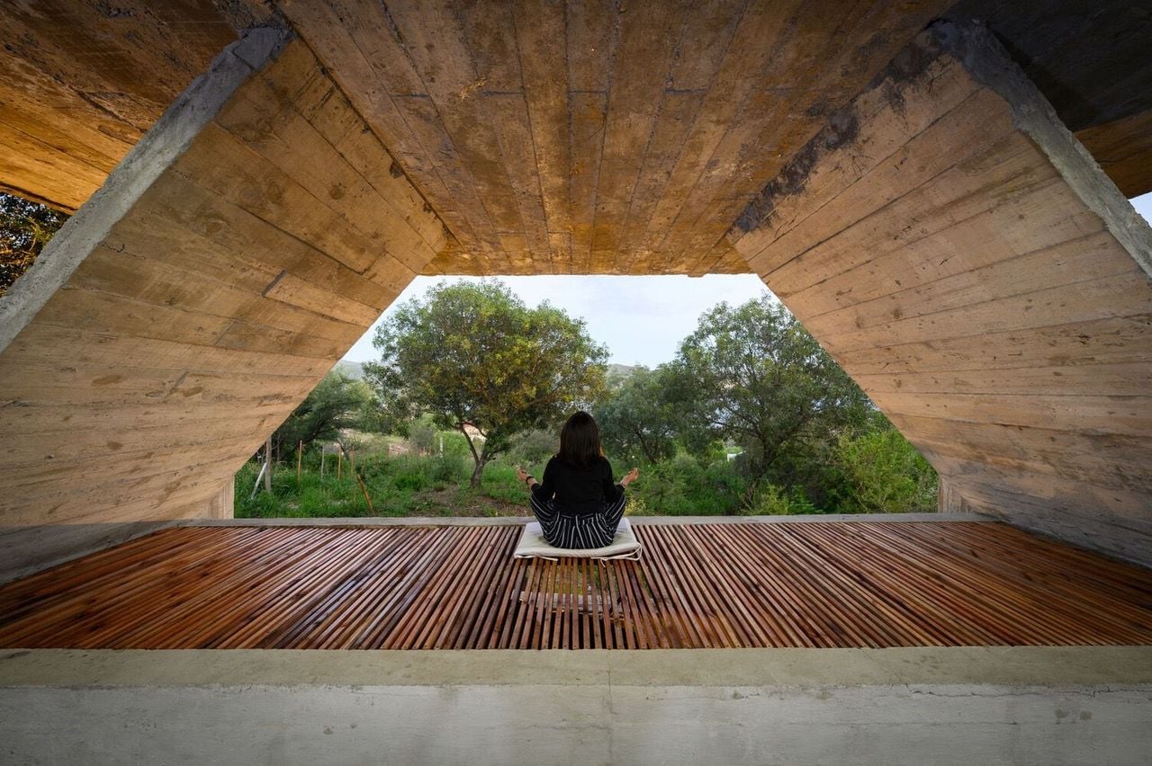 Woman centers herself in the meditation area of the Bioclimatic House's 