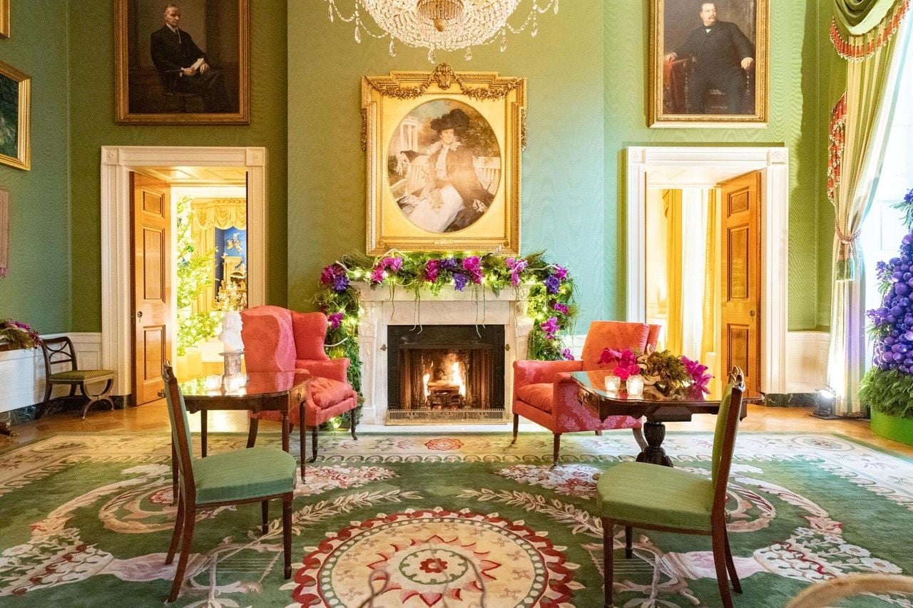 Living fuschia orchids woven into the Green Room mantle as part of First Lady Jill Biden's 2021 White House holiday decor.