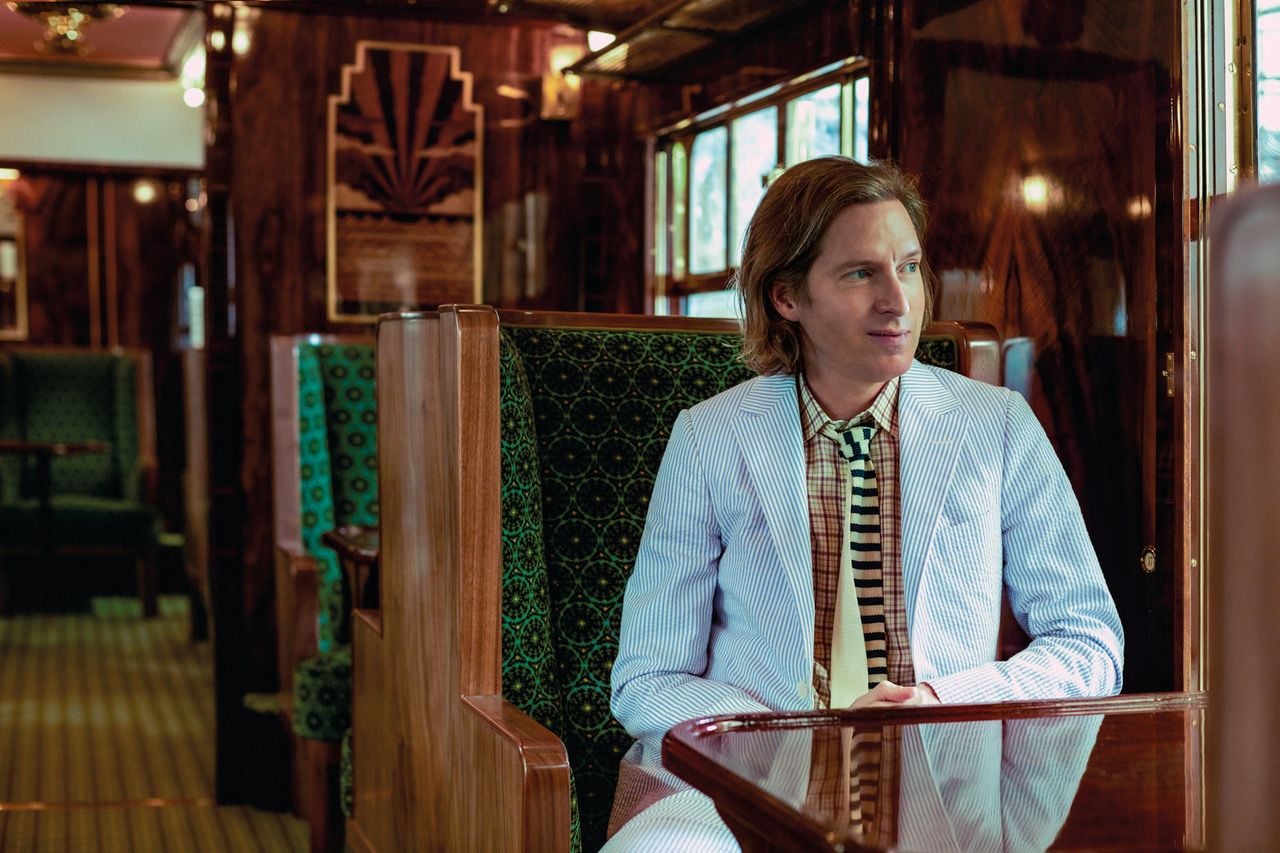 Wes Anderson smiles inside the 1950s-era Cygnus carriage he restored for London's Belmond British Pullman train. 