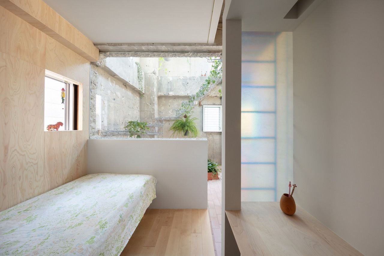Small minimalist bedroom space inside MAMM Design's renovated Tokyo residence.