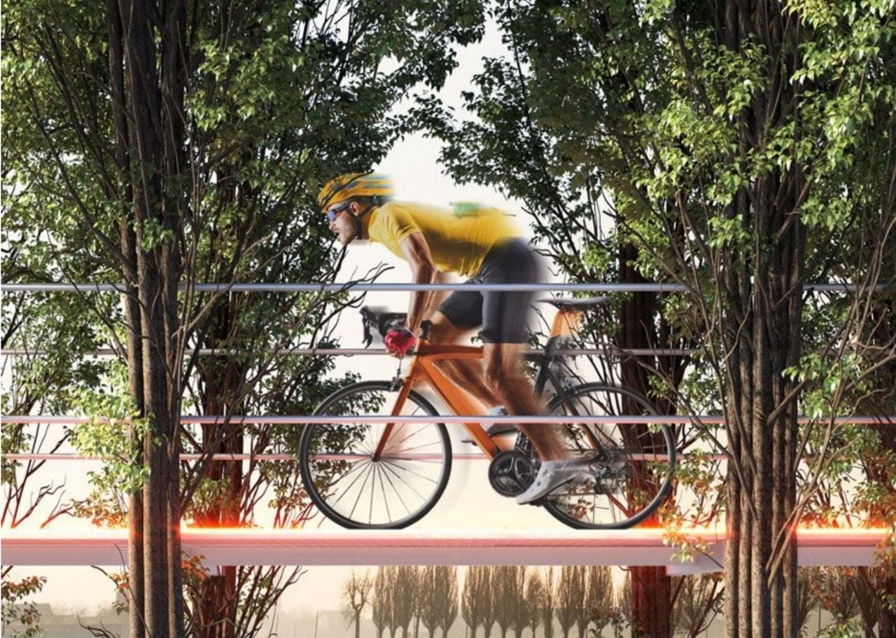 Cyclist zips through the trees holding up the Carlo Ratti Associati-designed Tree Path in northern Italy.