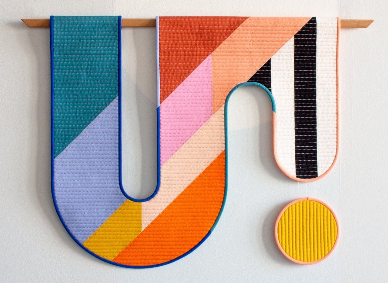 Curving color block wall hangings by artist Emily Van Hoff.