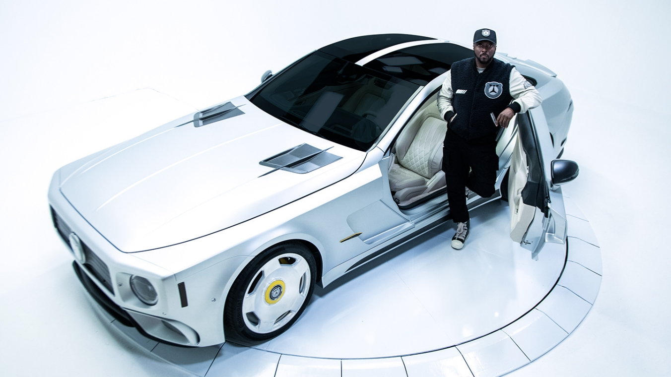 Musician will.i.am stands in front of the custom four-wheel 