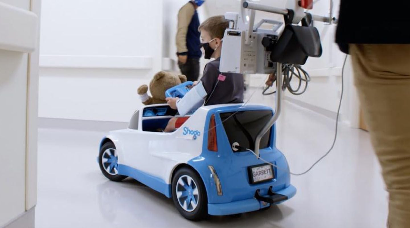 Child patient at Children's Health of Orange County drives the miniature Honda Shogo EV around the hospital.