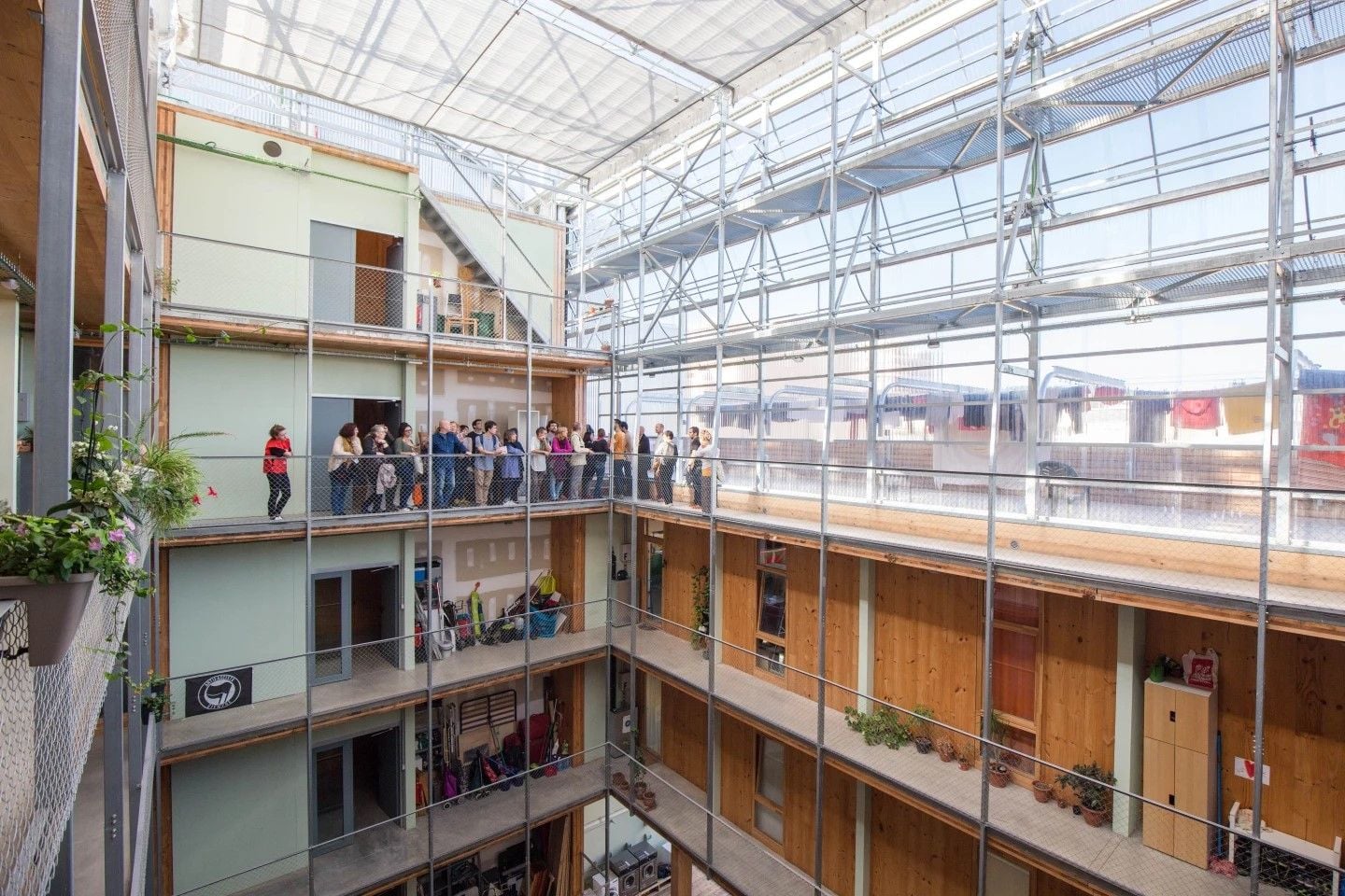 La Borda residents gather on the building's fourth floor overlooking the central courtyard.