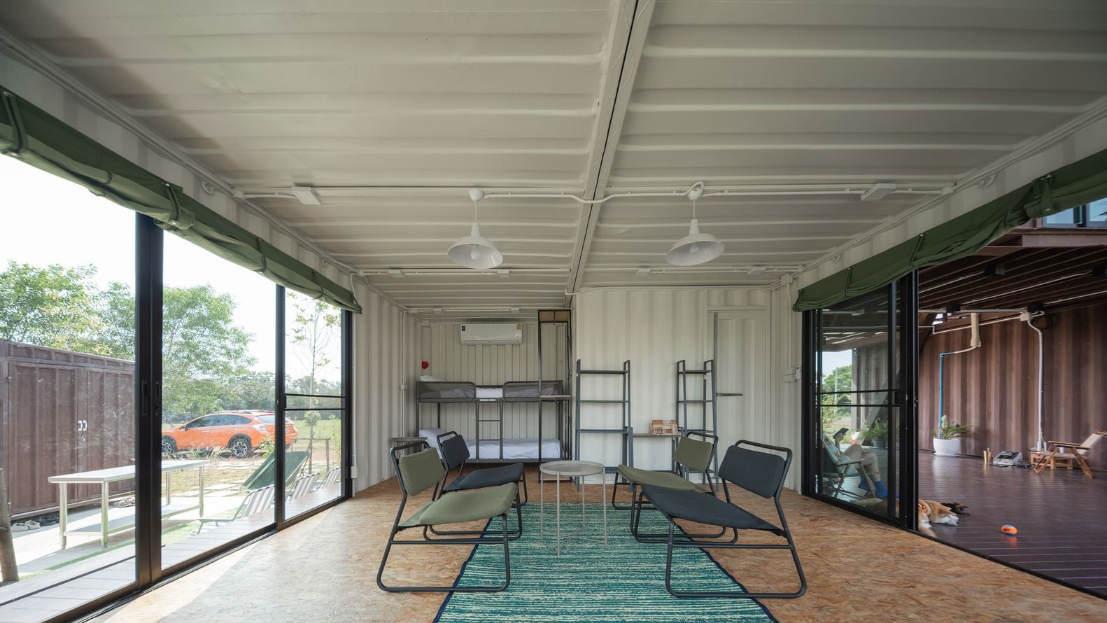 Interior sitting area in the Tung Jai Ork Baab-designed shipping container cabin in rural Thailand.