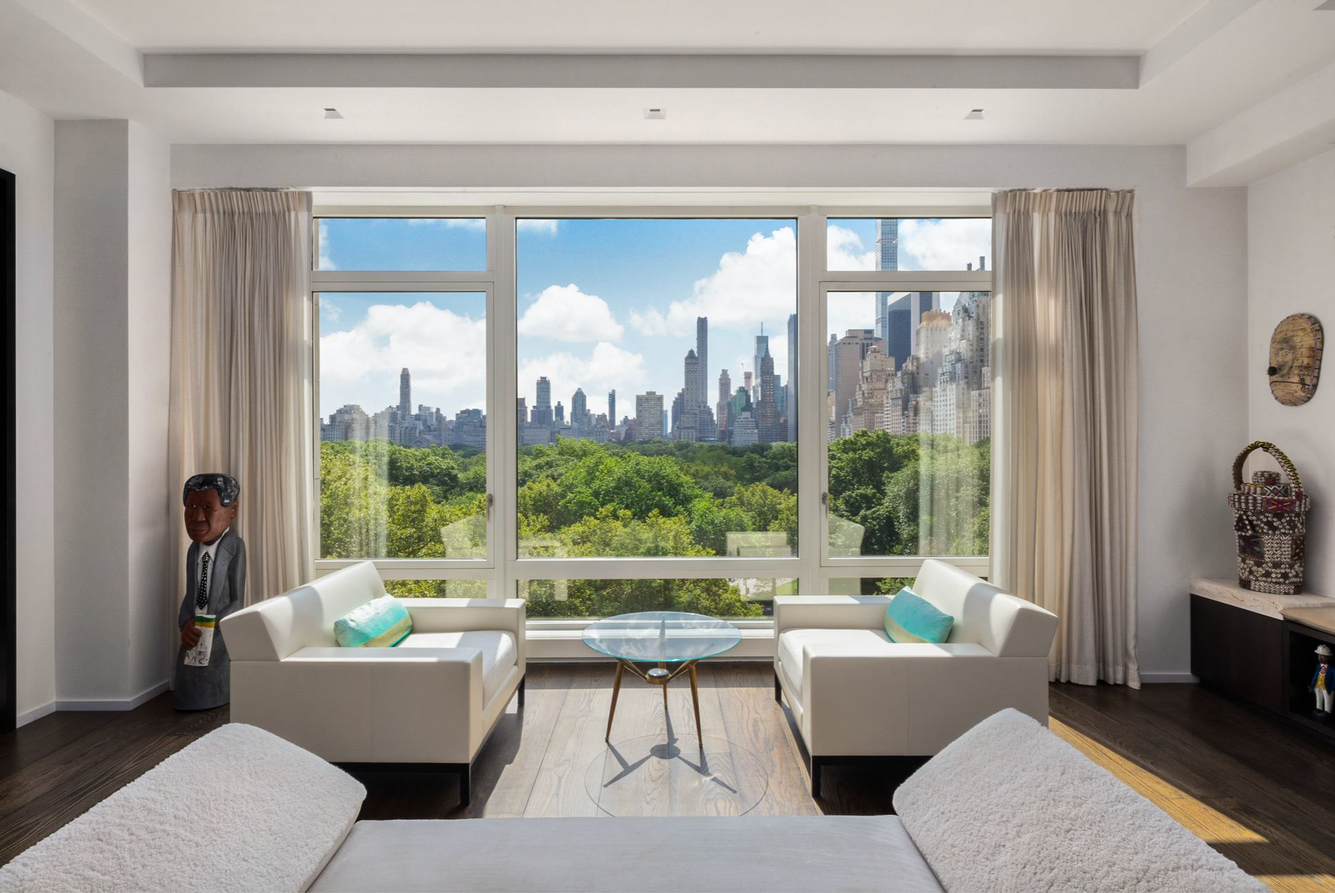 Main living area in the Jeffrey Beers-renovated apartment at 15 Central Park West, with gorgeous views of NYC visible just beyond the large windows.