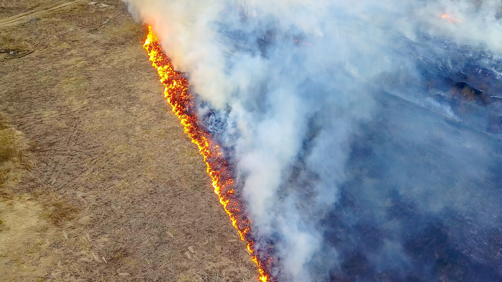 Aerial view of a wildfire ravaging drylands across the Western United States. 