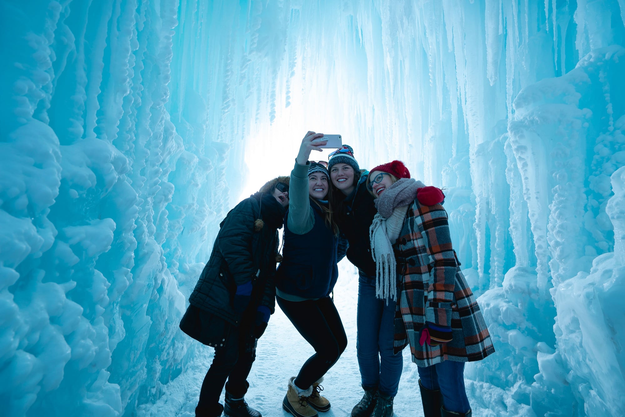 Group of friends poses for a photo inside one of Brent Christensen's ice castles.