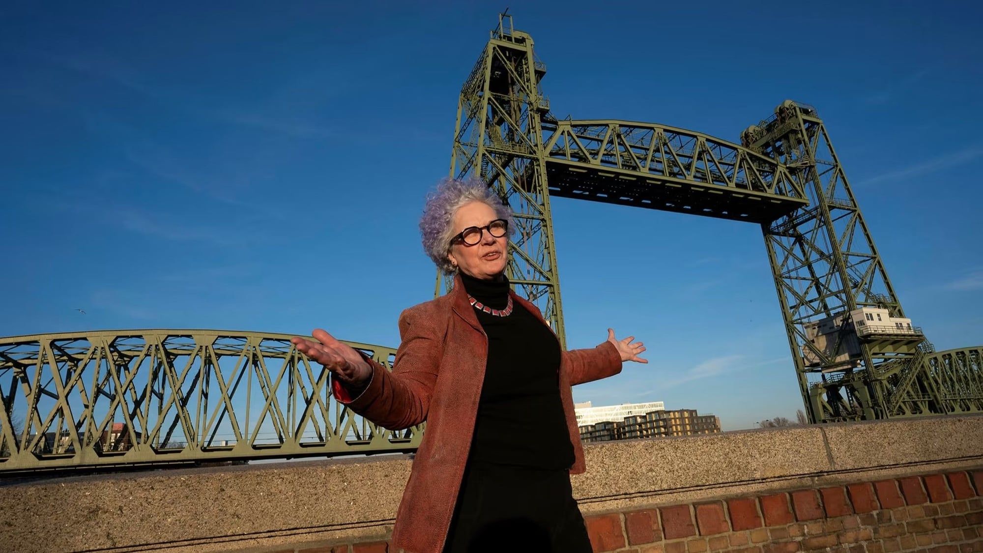 Rotterdam city council member Ellen Verkoelen stands in front of the city's Koningshaven Bridge. 