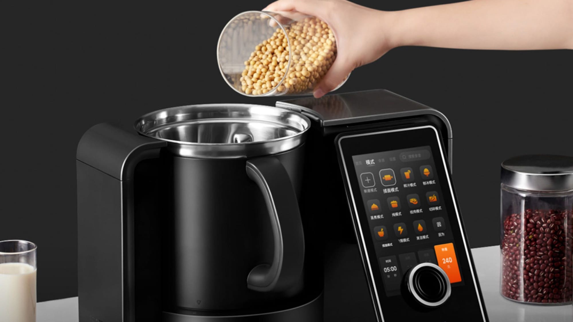 Person loads ignredients into the iF Design Award-winning Tokit Omni Cook Multi-Cooker. 