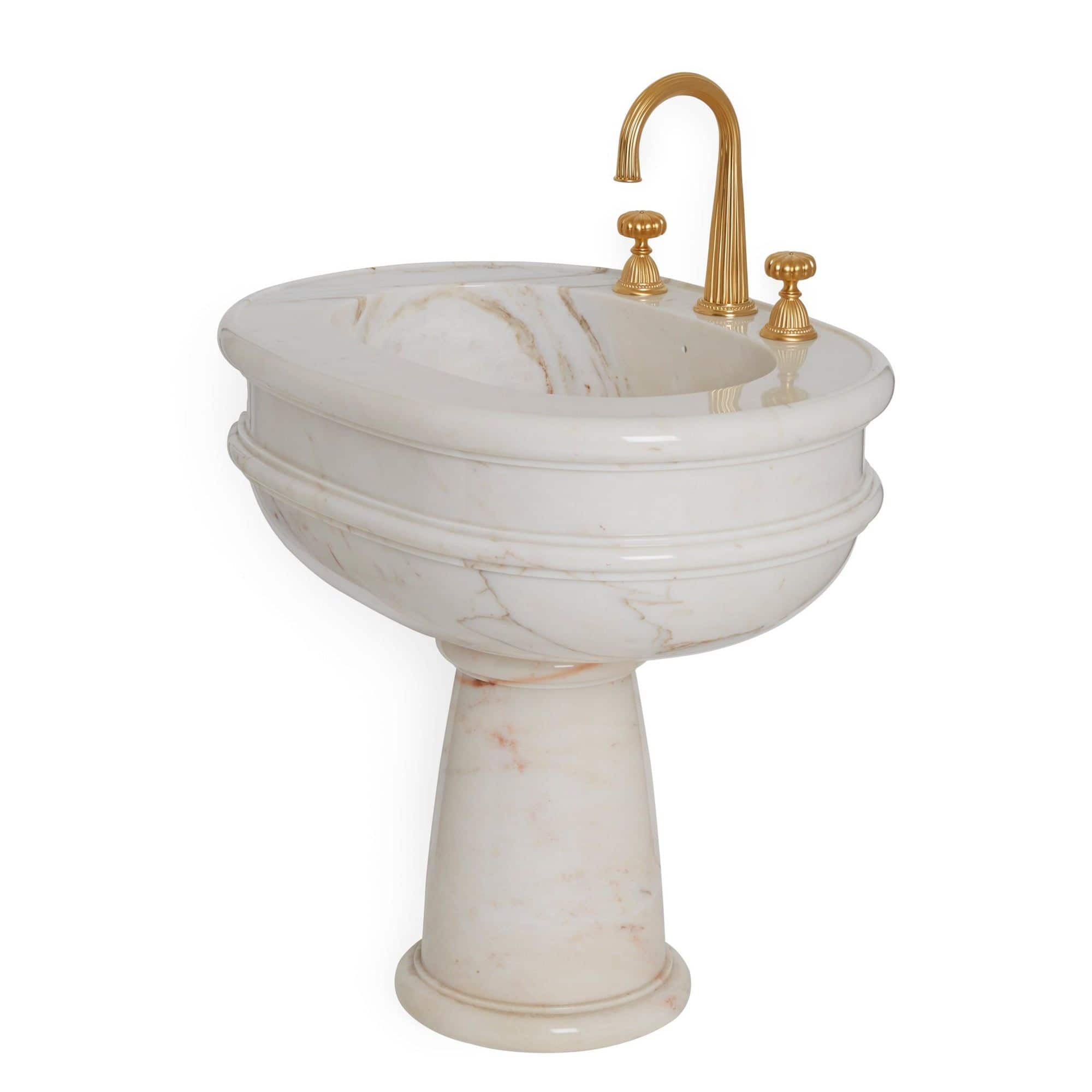 Luxurious gold and marble bathroom sink by Sherle Wagner.