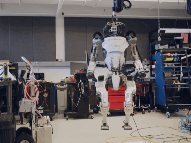 Boston Dynamics engineers perform a systems check on one of their Atlas robots.